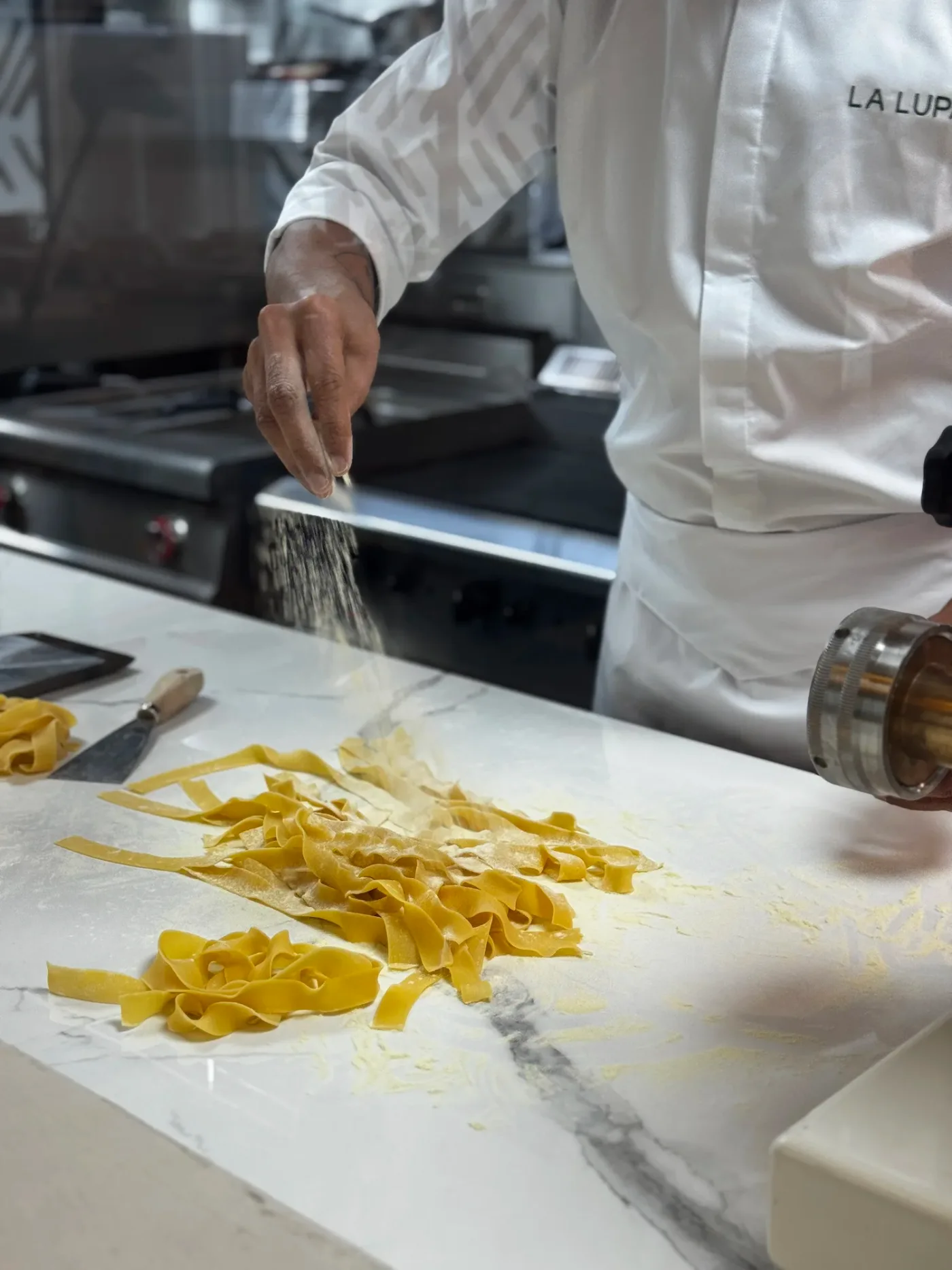 A La Lupa chef preparing fresh pasta in the restaurant kitchen